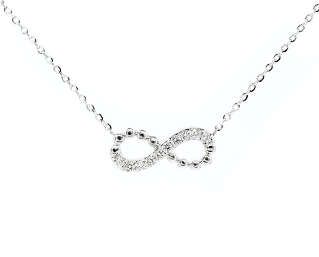 Colgante Infinity Oro Blanco 18k, con Diamante. Incluye cadena.
